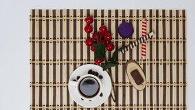 Coffee cup with sweets on wooden table background.