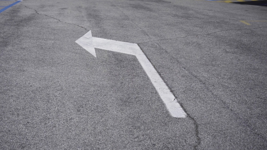 Left arrow drawn on the road