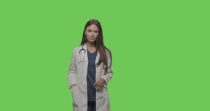 healthcare medicine concept. Female doctor look at camera, make video chat, have web cam conference at hospital on green screen background, chroma key . 4K RAW graded footage