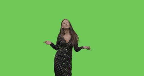 Happy smiling woman in beautiful dress dancing and having fun isolated on Green Screen, Chroma Key. 4k raw video footage slow motion 60 fps