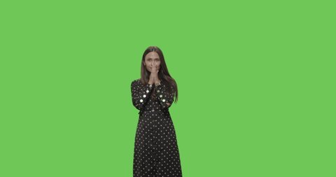 Young worried girl winner isolated over Green Screen background . Surprised girl laughing on Chroma Key. 4k raw video footage slow motion 60 fps
