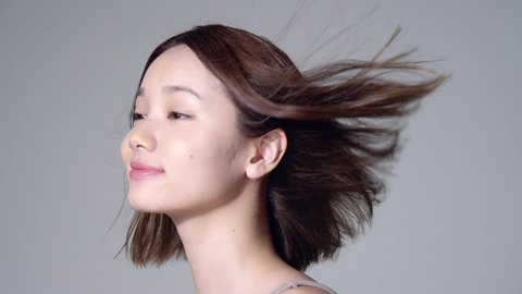 Beauty concept of an asian girl. Hair care. Skin care. Cosmetics. 60p slow motion.