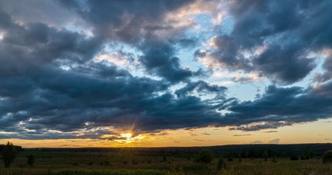4K Time lapse, beautiful sky with dark blue clouds background, Clouds at sunset. Sky with clouds, weather, nature, cloud blue, the rays of the sun shine through the clouds