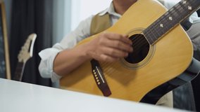 Music teacher hand image with records tutorial video how to play acoustic guitar at home of working at home and online learning, New normal working for social distancing 