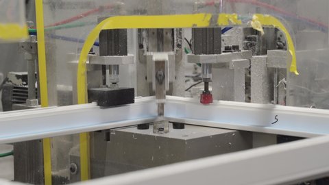 4K. Machine for cutting and cleaning welds on a plastic window. Milling of drainage holes and impost in the PVC window profile.