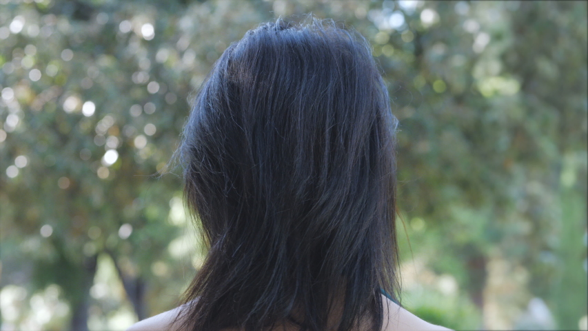 young sensual woman turning her head and looking at camera - oudoors