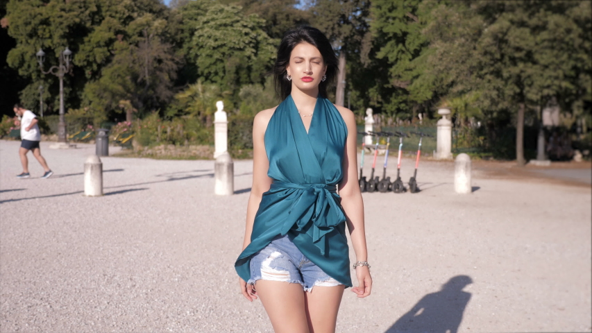 young sensual woman walking at pincio staring at camera - slow motion