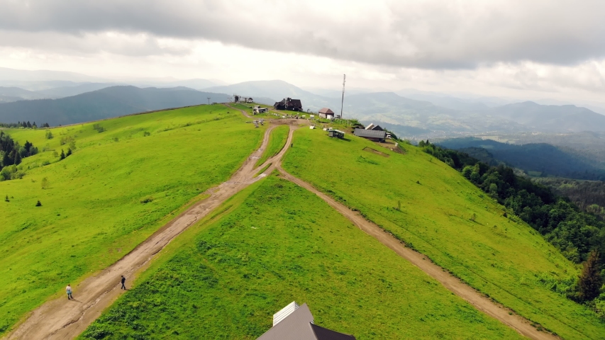 Aerial view mountain Vysokyi Verkh in the Ukrainian Carpathians is covered with green grass in summer.