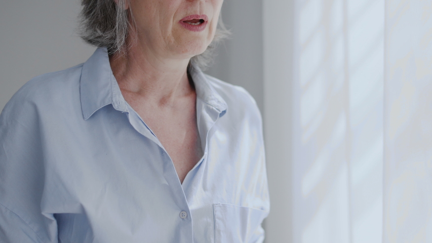 Gray-haired woman feeling pain in chest, heart attack or stroke symptoms | Shutterstock HD Video #1055317262