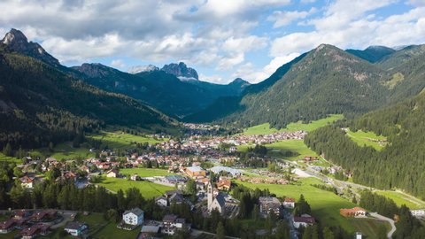 4K, aerial timelapse of dolomites landscape and local traditional town, the Alps, Province of Belluno, South Tyrol, Italy.
