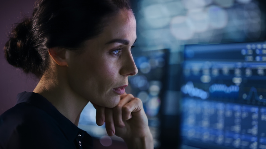 Confident Beautiful Middle Aged Woman Looks at Monitor Screens Focused. Professional Businesswoman Thinking Hard While Working on Computer in the Office. Closeup Face Portrait | Shutterstock HD Video #1055317553