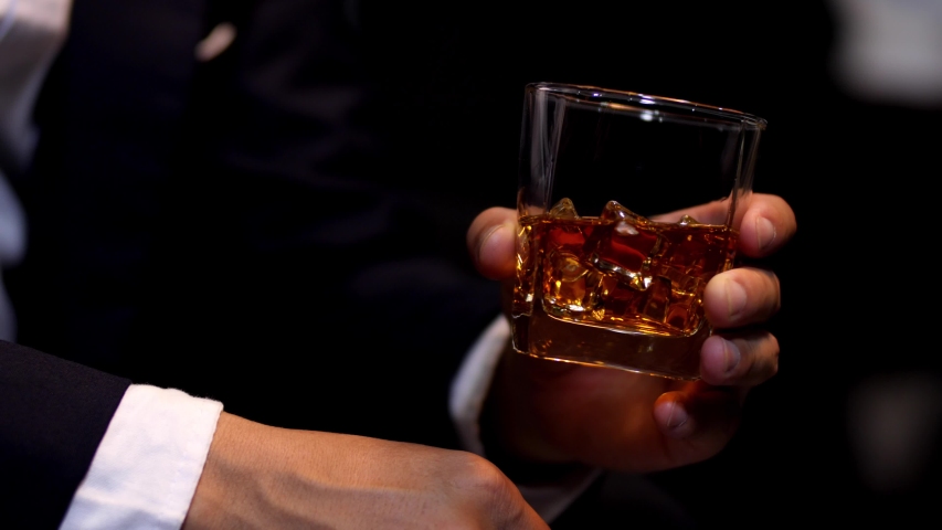 businessman holding whiskey, a restaurant Royalty-Free Stock Footage #1055319482