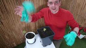 Male nerd makes video blog about growing plants at home. Online long distance teaching using video. Video call using high speed internet. Zoom call connection with friends.