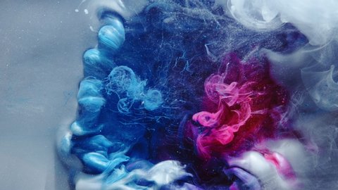 Color smoke cloud. Ethereal aura. Blue pink glitter ink spreading in water.