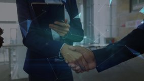 Animation of network of connections and globe over man and woman shaking hands using smartphone and digital tablet. Global business and network of connections concept digital composite. - Powered by Shutterstock - Get 15% off with code: PIKWIZARD15