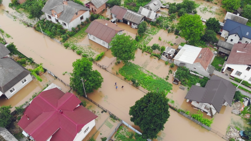 Aerial view Floods and flooded houses. Mass natural disasters and destruction. A big city is flooded after floods and rains.