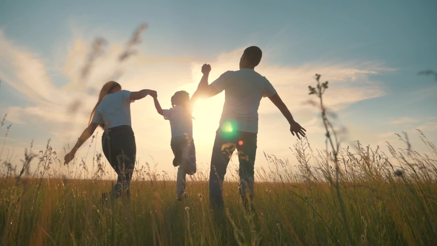 Happy family run in park at sunset. Teamwork. Parents and daughter are run at sunset. Silhouette of running happy family in park. Children are running. Silhouette of happy family in park Royalty-Free Stock Footage #1055347835