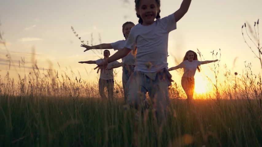 Happy family. Teamwork. Dream of becoming a pilot, Silhouette of happy family at sunset in the park. Teamwork, airplane pilot. Children dream. Silhouette of children in the park playing airplane pilot | Shutterstock HD Video #1055349605