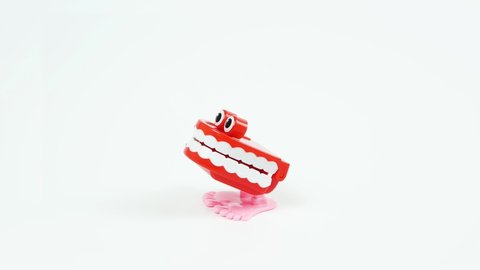 Chattering teeth toy stops in the middle, white background