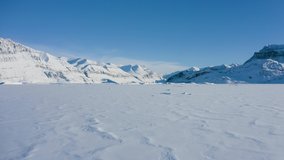 Droneflight over the polar region, a frozen sea including icebergs and icy, cold snowy mountain peaks in the arctic, ellesmere island, north pole - Powered by Shutterstock - Get 15% off with code: PIKWIZARD15