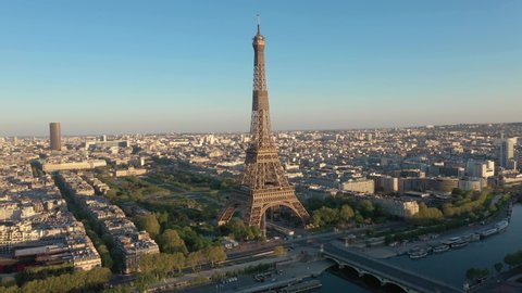 Paris drone, France, Tour Eiffel tower at sunset or sunrise with Champ-de-Mars garden. 4k quality drone shot, aerial view above Seine river from right to left