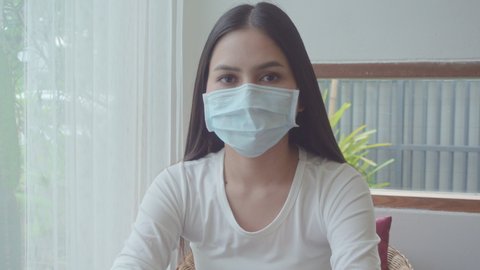 a young woman  is taking off her face mask , happy with Coronavirus pandemic is disappear 
