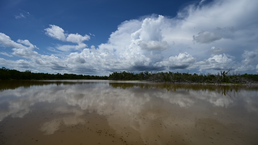 Timelapse of clouds forming over Eco Pond in Everglades National Park, Florida in summer 4K.