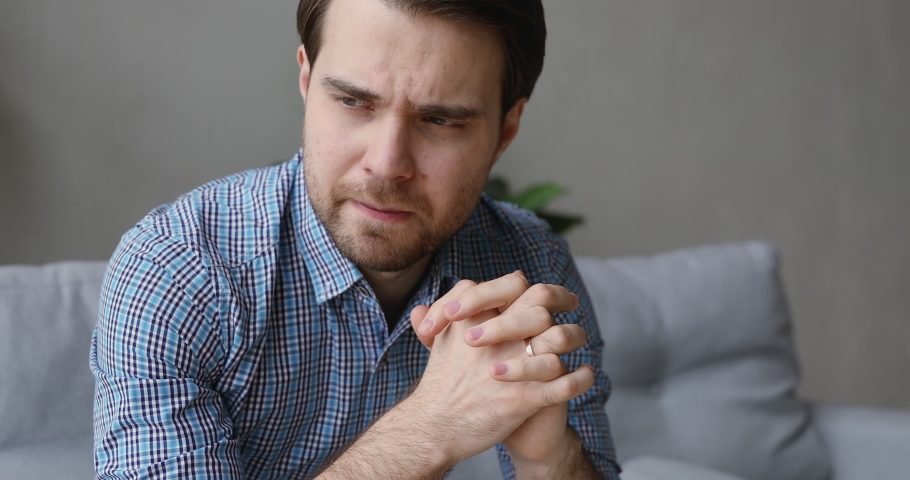 Close up view 35s man in casual shirt sit on sofa in living room at home feels unhappy due personal life troubles break up divorce marriage split, repenting guilty man, debt financial problems concept | Shutterstock HD Video #1055363111