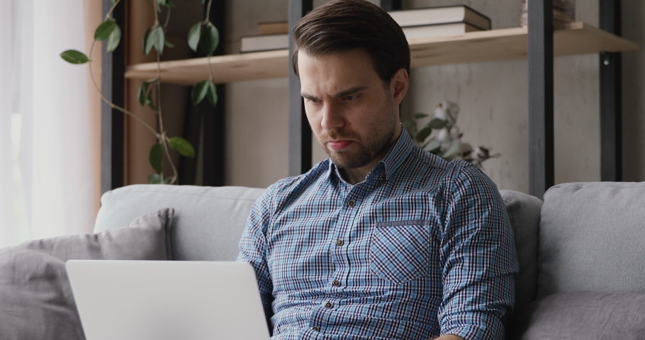 Man sitting with laptop received badly news feels frustrated cover face with palm looks very disappointed lost document works unsaved project, problems with device, unpleasant news by e-mail concept Royalty-Free Stock Footage #1055363168