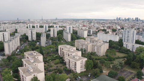 France, Paris suburb, Gennevilliers, HLM buildings. Eiffel tower and La Défense in the background. Backward drone aerial view