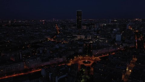 France, Paris, Tour Montparnasse tower illuminated at night. drone shot, aerial view