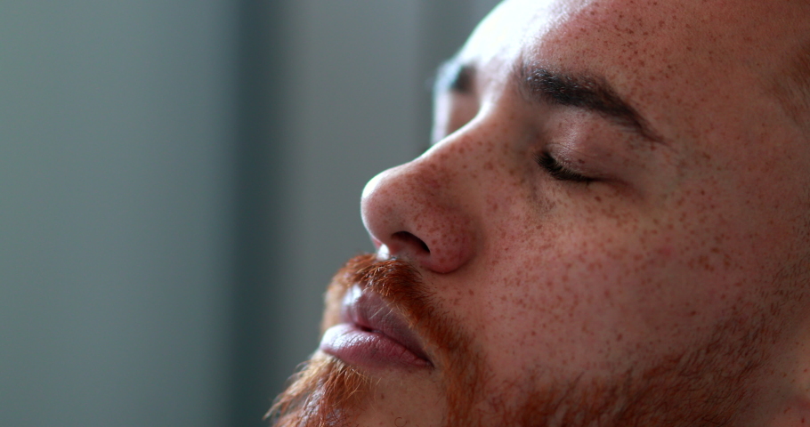 Man opening eyes looking up smiling, close-up redhead face man looks up Royalty-Free Stock Footage #1055364146