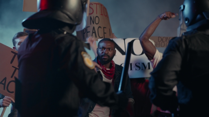 Crowd of Multi-ethnic Furious Strong Men Fighting with Brutal Police Protesting for Human Rights on Street Demstration. Black Lives Matter. Stop Racism. Royalty-Free Stock Footage #1055365034