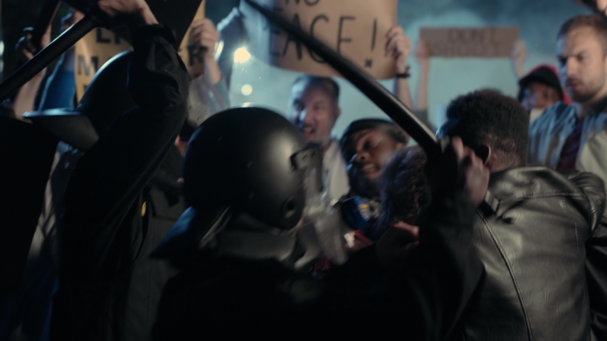Black Multi-ethnic Men Activists Fighting with the Brutal American Police Officers on Public Rebellion. Street rally. Demonstration. Antiracism. Black Lives Matter. Royalty-Free Stock Footage #1055365043