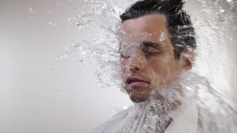 Water splash on face of a man
