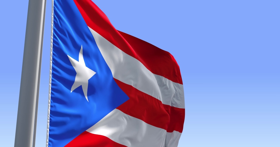 Puerto Rico flag on a flagpole waving in the wind in the sky. Wonderful intro for yor projects. The Commonwealth of Puerto Rico. Royalty-Free Stock Footage #1055373596