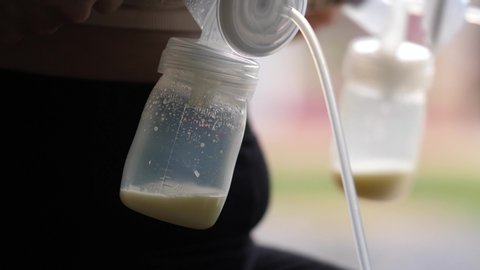 mother using single electric breast milk pump and pumping breast milk for her baby. Breast milk for supplementary feeding, infant nutrition.