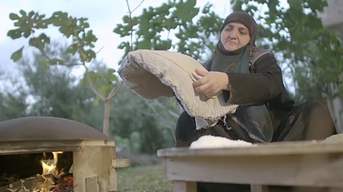 LEBANON - CIRCA 2019: Lebanese woman prepares dough to make traditional Lebanese bread, slow motion