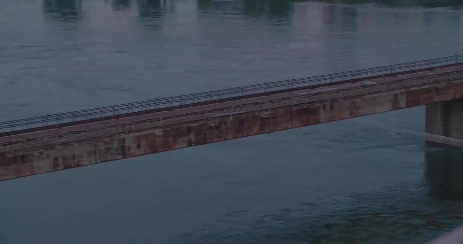 Montreal, QC, Canada - April 15 , 2017: Pan shot of Saint Lawrence River, Suicide barrier, Traffic on Jacques Cartier Bridge during the evening.
