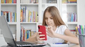 Kid Using Smartphone Studying in Video Conferencing, Child Learning, Writing in Library, Blonde Schoolgirl Chatting with Teacher at Home in Coronavirus Pandemic Crisis, Homeschooling, Online Education