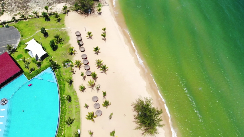 High quality royalty free stock footage, Aerial view of tropical sandy beach with palms and calm sea . Shot in Vietnam ,Phu Quoc, Romantic beach from the top video concept with beach resorts