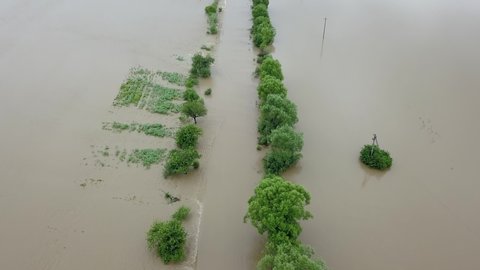 Aerial view flooded road heavy rain flooding taken during drone flight overflowing river storm water, danger wet disaster damage grass, climate lake high stream season environmental ecology rural