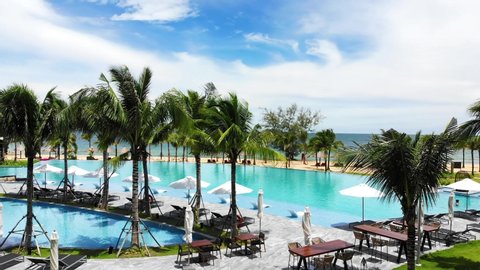 Aerial view of Swimming pool in the resort at Phu Quoc, Vietnam. Romantic beach from the top video concept with beach resorts 