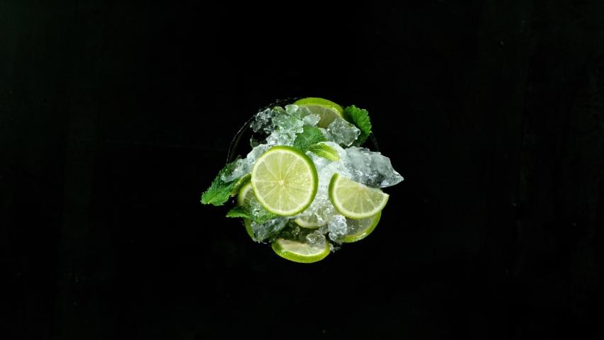 Refreshing mojito cocktail vortex on black stone table, slow motion filmed on high speed cinematic camera. Royalty-Free Stock Footage #1055391965