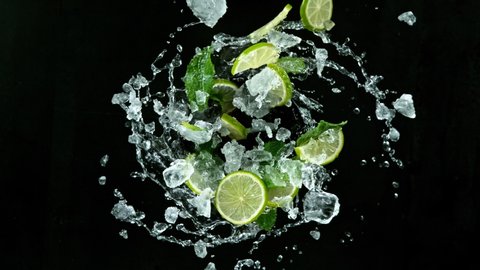 Refreshing mojito cocktail vortex on black stone table, slow motion filmed on high speed cinematic camera.