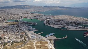 Aerial drone rotational video of famous port of Piraeus where passenger ferries travel to popular Aegean destinations as seen from high altitude, Attica, Greece