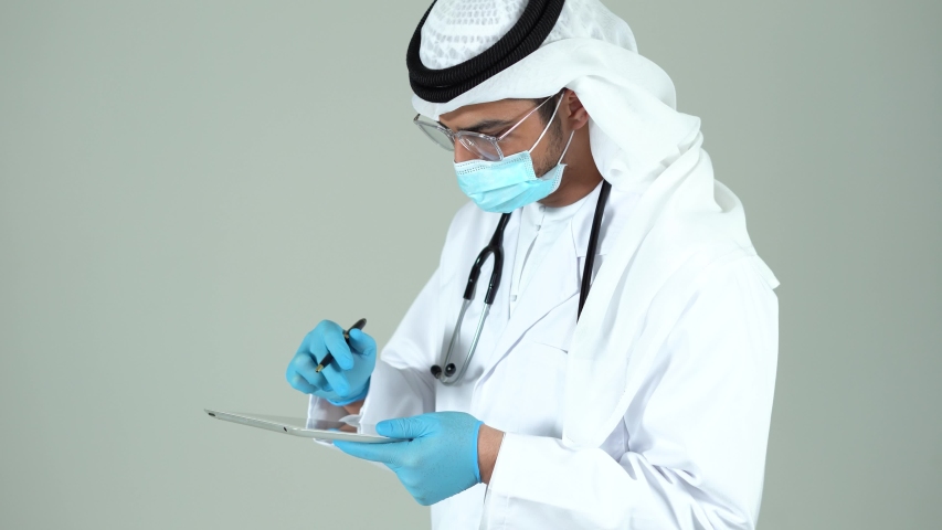 Healthcare And Medicine technology Concept / Arabic Doctor using a digital tablet at the hospital
