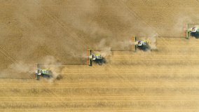 Top down view of Harvester machines working in wheat field . Combine agriculture machine harvesting golden ripe wheat field. - Powered by Shutterstock - Get 15% off with code: PIKWIZARD15