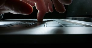 Close up shot of hands typing on keyboard of laptop computer. Unrecognizable person pressing the buttons with fingers, isolated on black background 4k footage