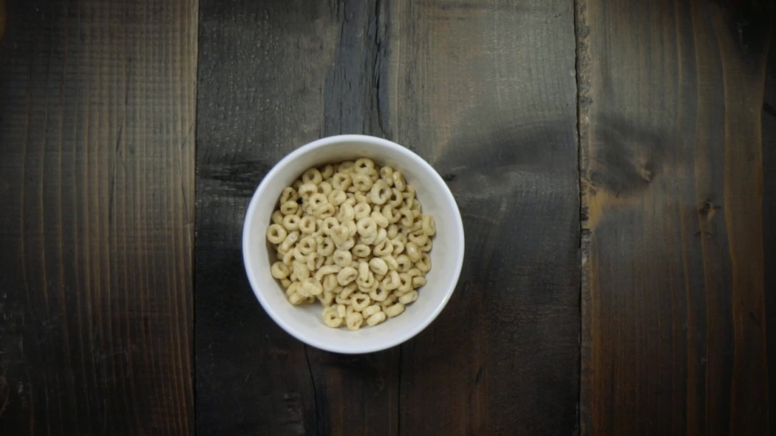 Unique view of milk being poured into a bowl of cereal